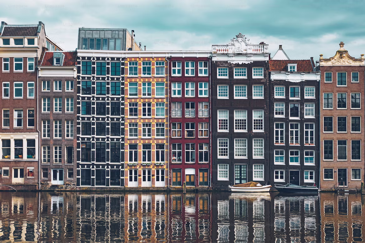The iconic row of gabled canal houses along a canal in Amsterdam, Netherlands