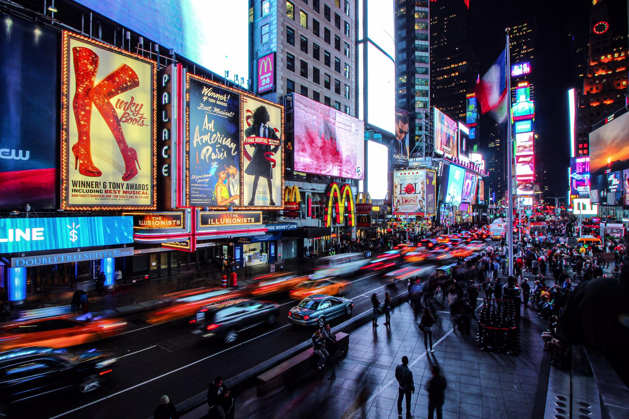 Times Square at night with neon lights and busy streets, New York City