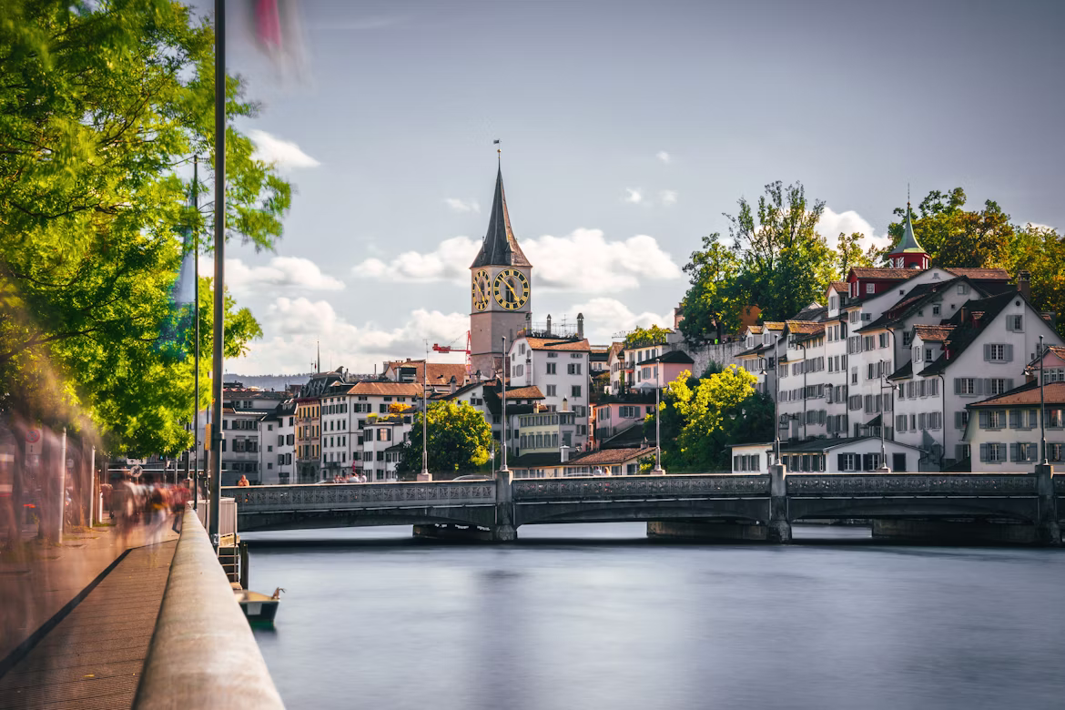 Zurich riverside view of the Fraumünster clock tower along the Limmat, Switzerland